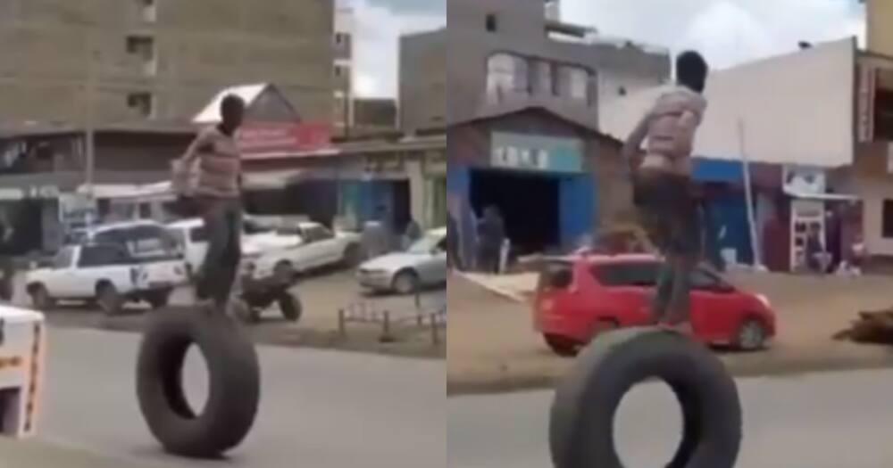 Daring Man Braves Dangerous Walk on a Large Tyre in a Busy Street