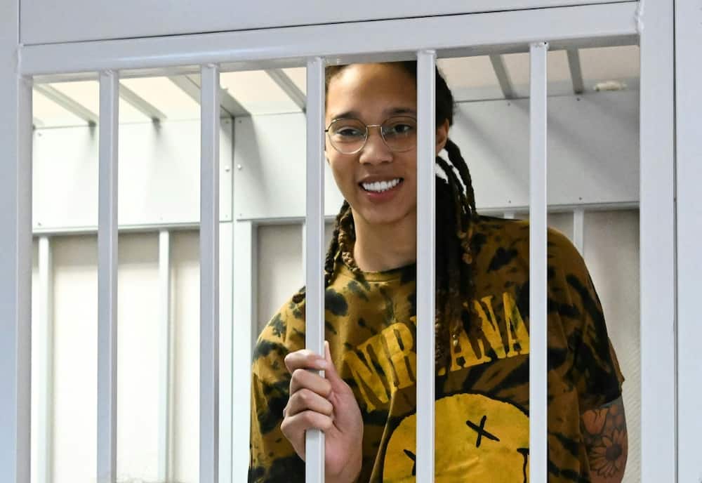 US WNBA basketball superstar Brittney Griner smiles inside a defendants' cage during a hearing in the town of Khimki outside Moscow on July 15, 2022