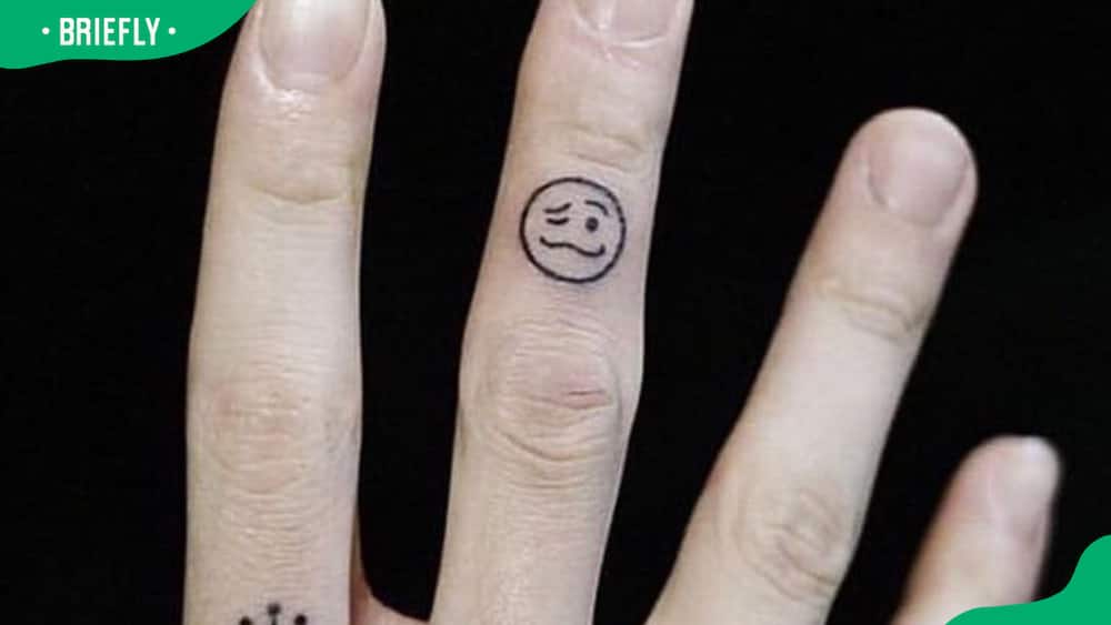 Jungkook's woozy face emoticon tattoo