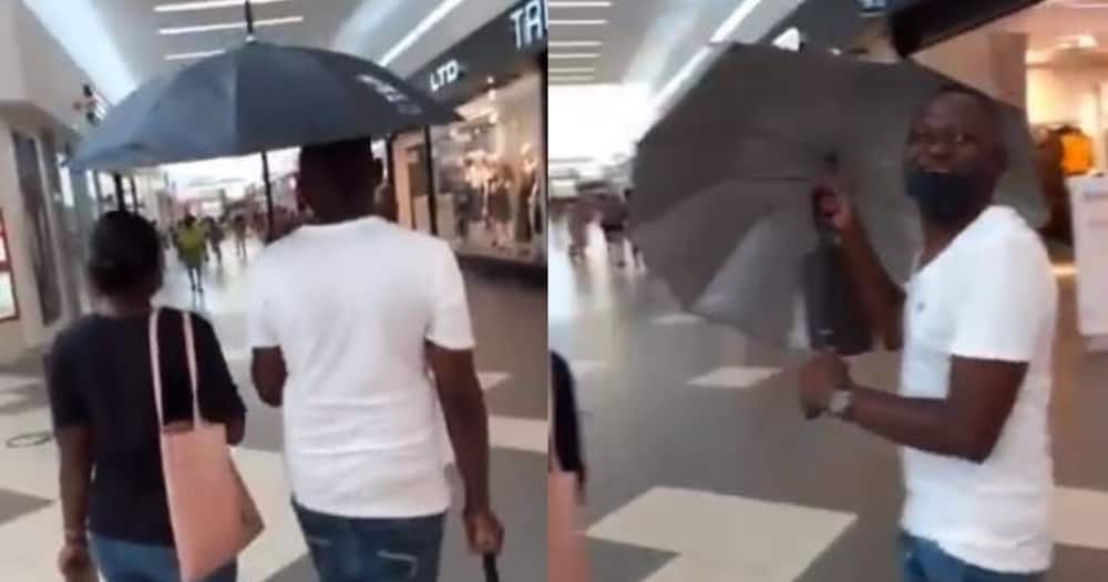 Guy's mind preoccupied with other things, forgets to close his umbrella
