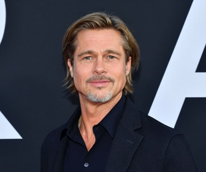 Brad Pitt on a navy blue shirt and suit