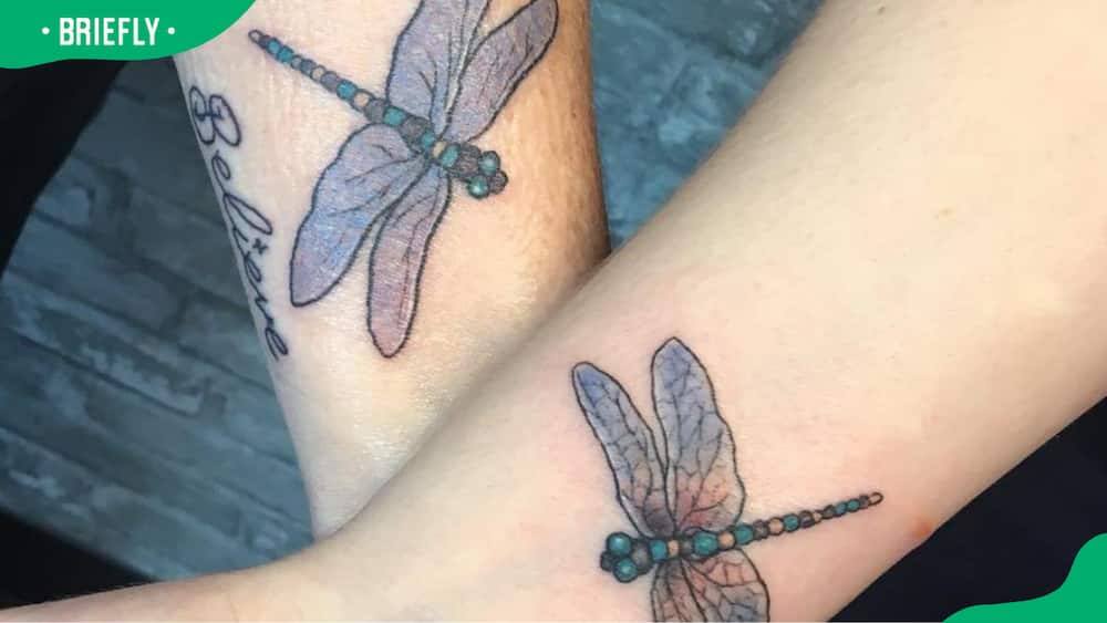 Matching dragonfly wrist tattoos