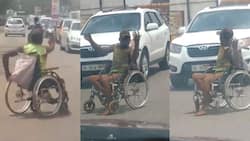 Disabled man in wheelchair captured in video busily directing traffic in the hot sun