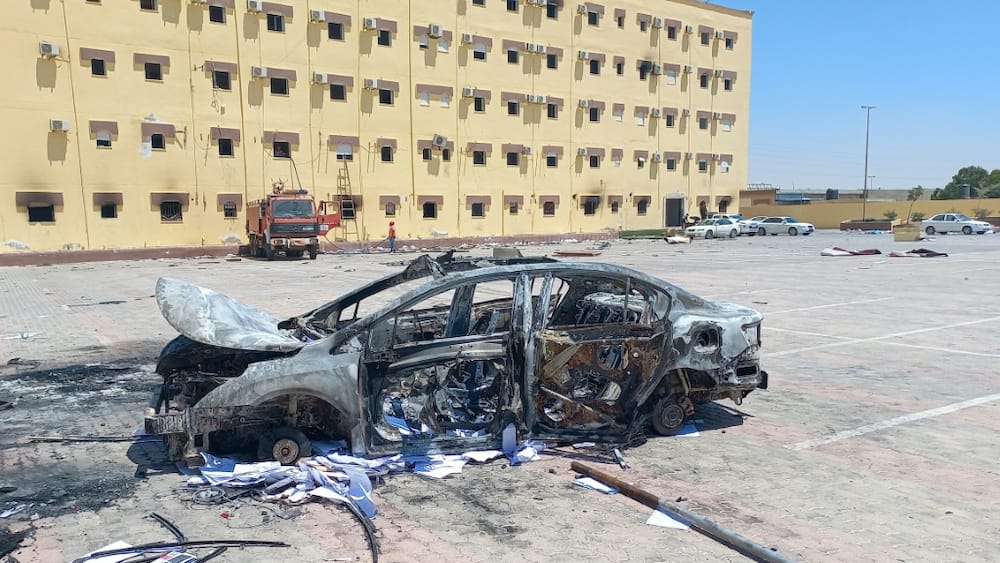 A burnt vehicle outside the House of Representatives in the eastern city of Tobruk on July 2, 2022, after angry protesters stormed the building ransacking its offices and torching part of it