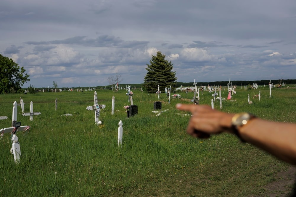 Eric Large, former Saddle Lake First Nation chief and onetime student at the Blue Quills Indian Residential School, points to where unmarked graves have been found in Saddle Lake Cemetery on Saddle Lake Cree Nation in Alberta, Canada