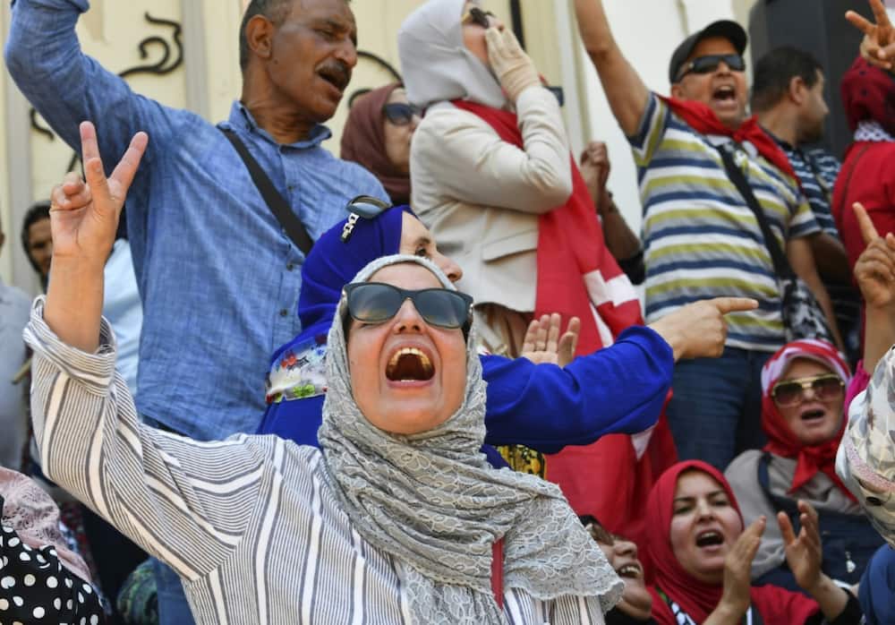 Tunisian protesters chant slogans against President Kais Saied and the upcoming constitutional referendum in the capital Tunis on June 19
