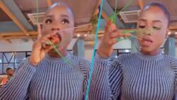“I prefer not to speak": Peeps react as pretty lady eats fries and chicken with long nails in video