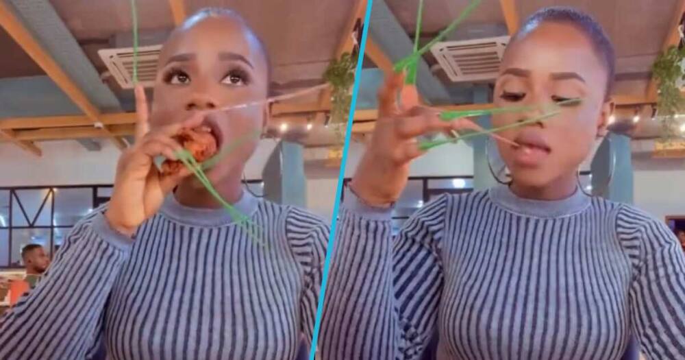 A woman struggled to eat chicken and chips with her long nails
