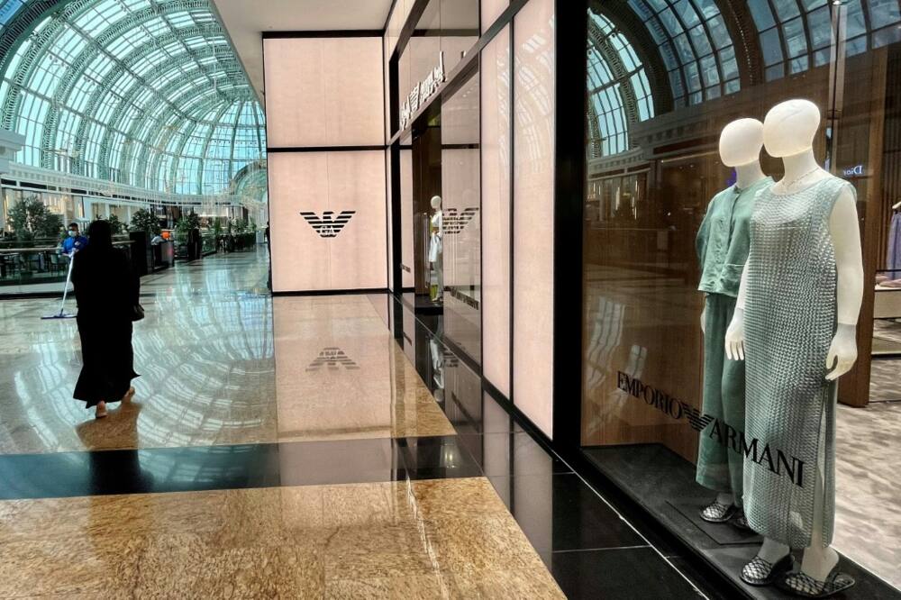A woman walks past an Armani shop in the Mall of the Emirates in Dubai