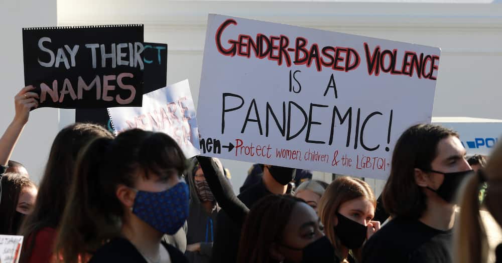 Protesters hold signs and shout slogans as they take part in a march against gender based violence and in solidarity with women who have been subject to violence and in memory of those who have been killed