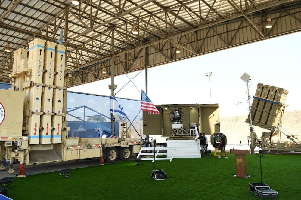 A handout picture released by Israel's defence ministry shows the Iron Beam (C) and David's Sling (L) systems, part of Israel's multi-tiered air defence system, on display at Israel's Ben Gurion airport ahead of US President Joe Biden's visit