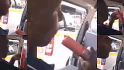 Hungry Mzansi man munches on an entire roll of polony during taxi ride