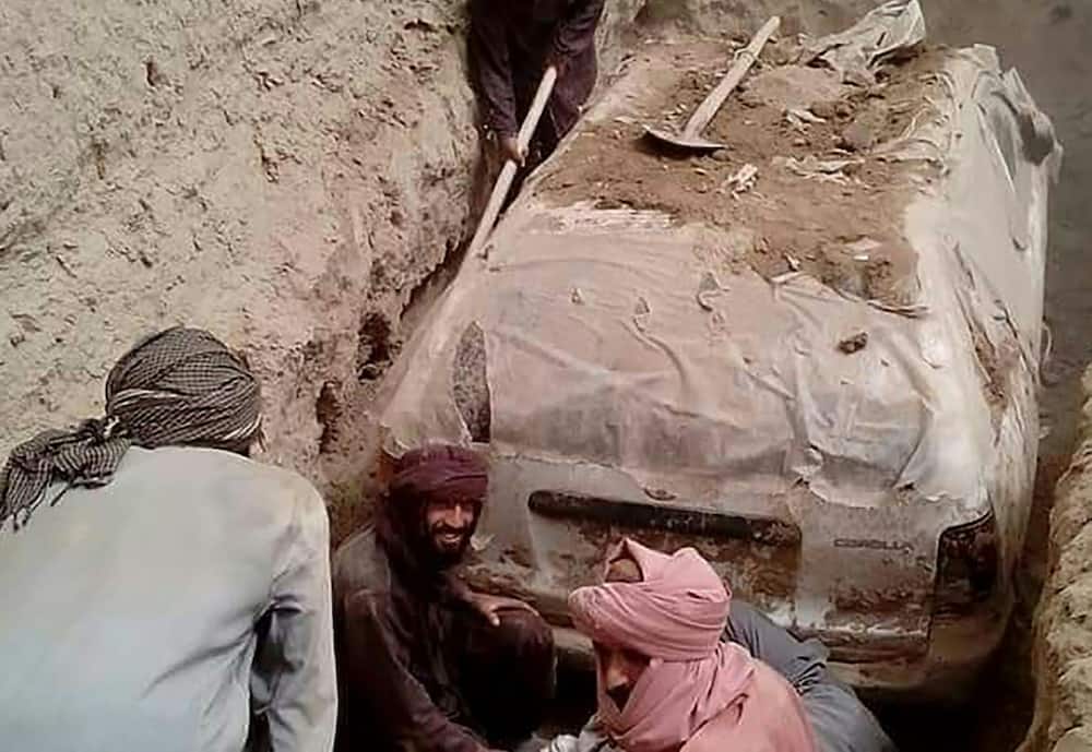 The white Toyota Corolla was buried in a village garden in Zabul province by Taliban official Abdul Jabbar Omari, who ordered it to be dug up this week. 
 In this undated handout picture released by Taliban media officials on July 7, 2022, Taliban members dig up a Toyota Corolla, used by Taliban founder Mullah Omar to escape being targetted by US forces after 9/11, at Omrazai village in Seyora district of Zabul province.