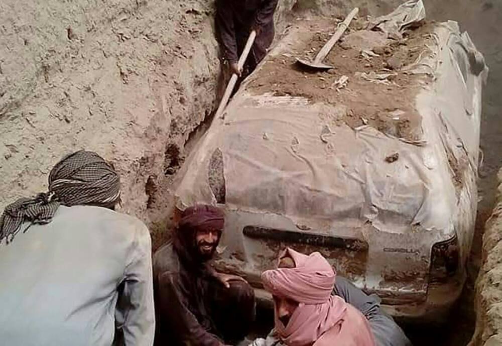 The white Toyota Corolla was buried in a village garden in Zabul province by Taliban official Abdul Jabbar Omari, who ordered it to be dug up this week.
In this undated handout picture released by Taliban media officials on July 7, 2022, Taliban members dig up a Toyota Corolla, used by Taliban founder Mullah Omar to escape being targetted by US forces after 9/11, at Omrazai village in Seyora district of Zabul province. The white Toyota Corolla was buried in a village garden in Zabul province by Taliban official Abdul Jabbar Omari, who ordered it to be dug up this week.
In this undated handout picture released by Taliban media officials on July 7, 2022, Taliban members dig up a Toyota Corolla, used by Taliban founder Mullah Omar to escape being targetted by US forces after 9/11, at Omrazai village in Seyora district of Zabul province.