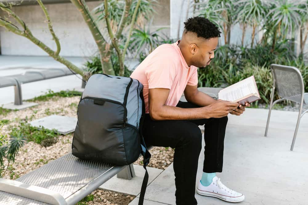 A male student reading a book
