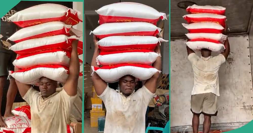 Man carrying five bags of rice on his head.