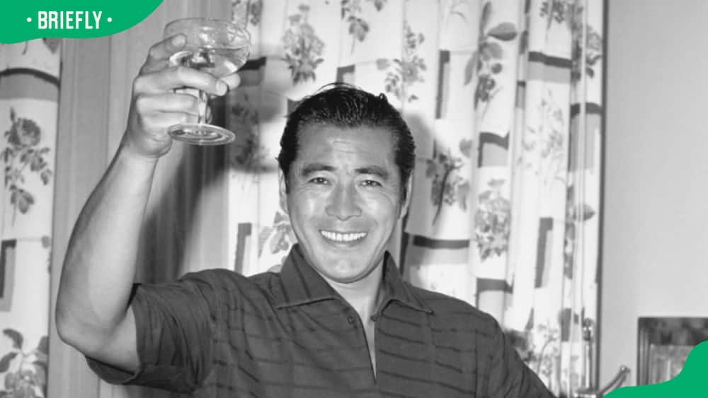 The famous Japanese actor, Toshiro Mifune raising a glass