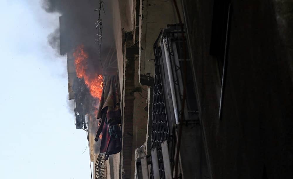 Flames pour out of a blazing building in Gaza City following an Israeli air strike