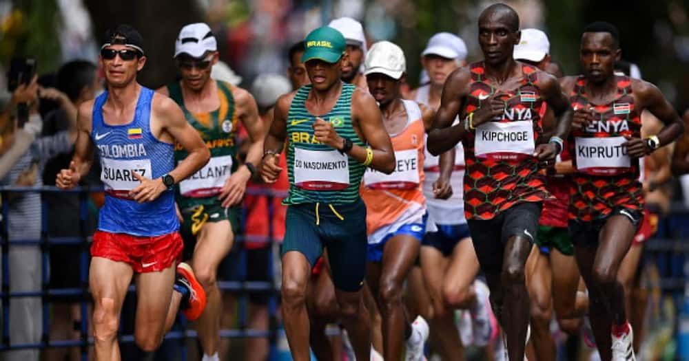 Runners, from left, Jeison Alexander Suarez of Colombia, Daniel Do Nascimento of Brazil, Eliud Kipchoge of Kenya, and Amos Kipruto of Kenya during the men's marathon at Sapporo Odori Park. (Photo By Ramsey Cardy/Sportsfile via Getty Images)