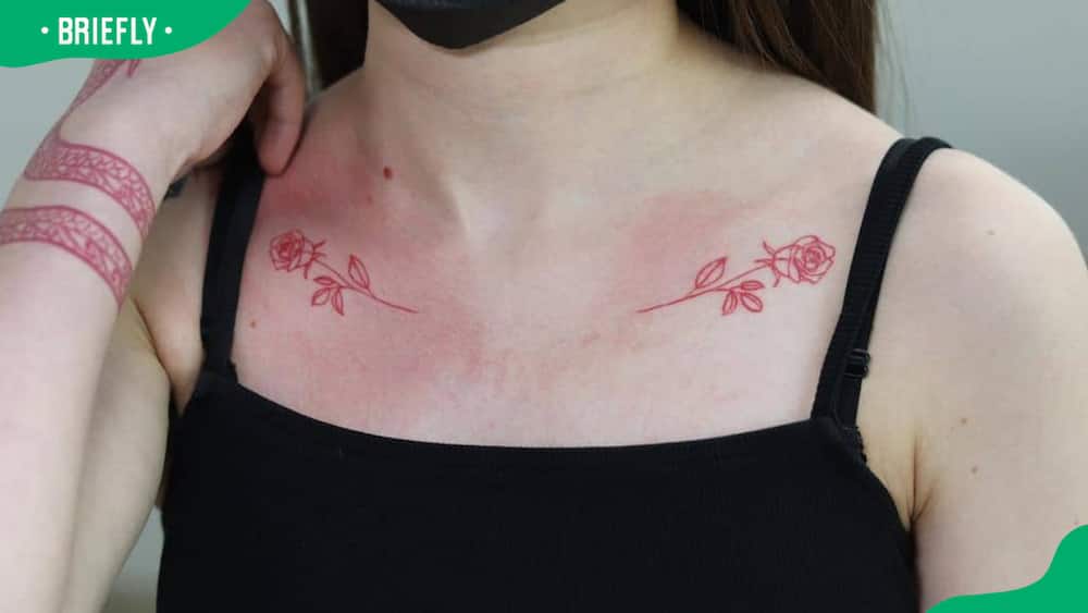 Matching red roses on collarbones
