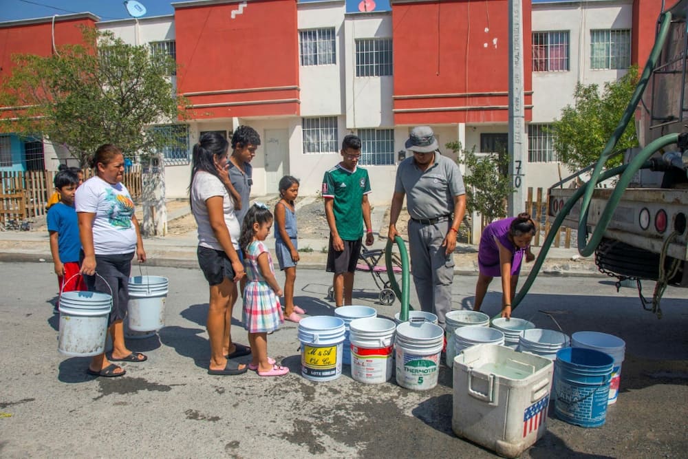 Residents of the northern Mexican city Monterrey queue for drinking water delivered by a tanker truck