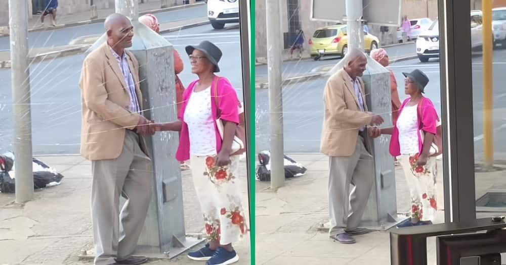 A TikTok video of an old couple standing in the street.