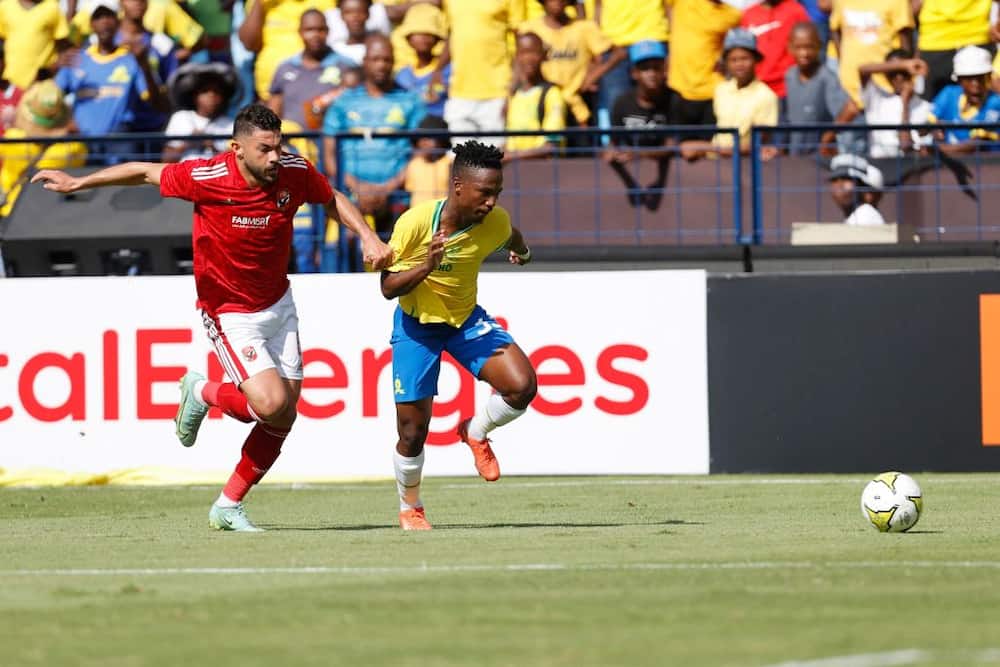 Ahly's Yasser Ibrahim (L) fights for the ball with Sundowns' Cassius Mailula