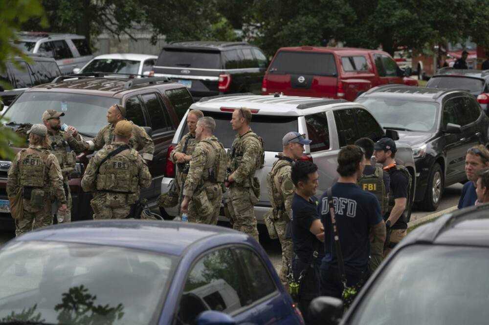 Officers gather at the scene of the Fourth of July parade shooting in Highland Park, Illinois on July 4, 2022