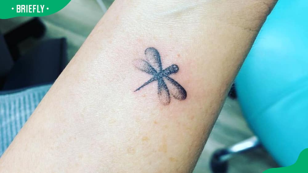 small dragonfly wrist tattoo