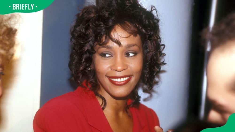 The late Whitney Houston posing for a photo