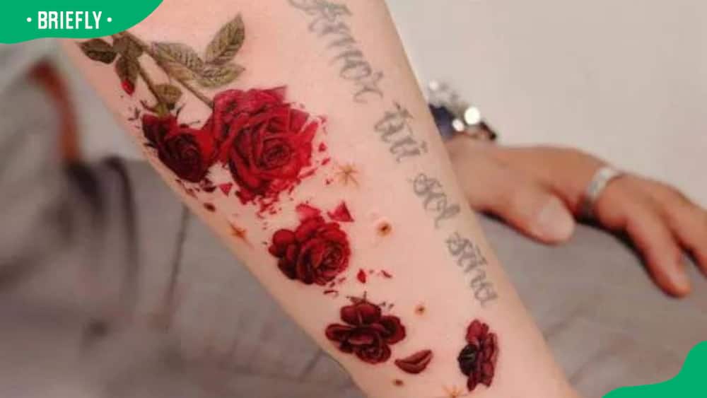 Rose and petals forearm tattoo