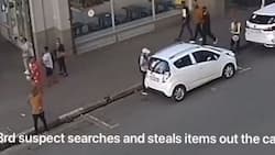 Car guard stands by as thugs break into car and walk away with valuables, video leaves SA angry