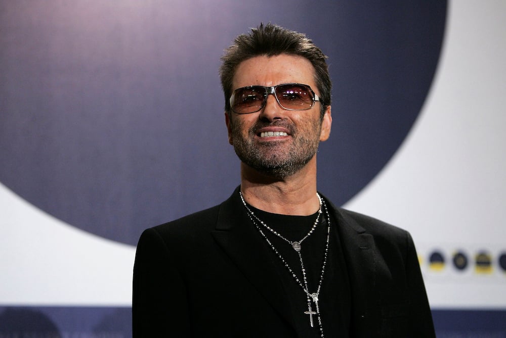 George Michael poses at the George Michael: A Different Story photocall