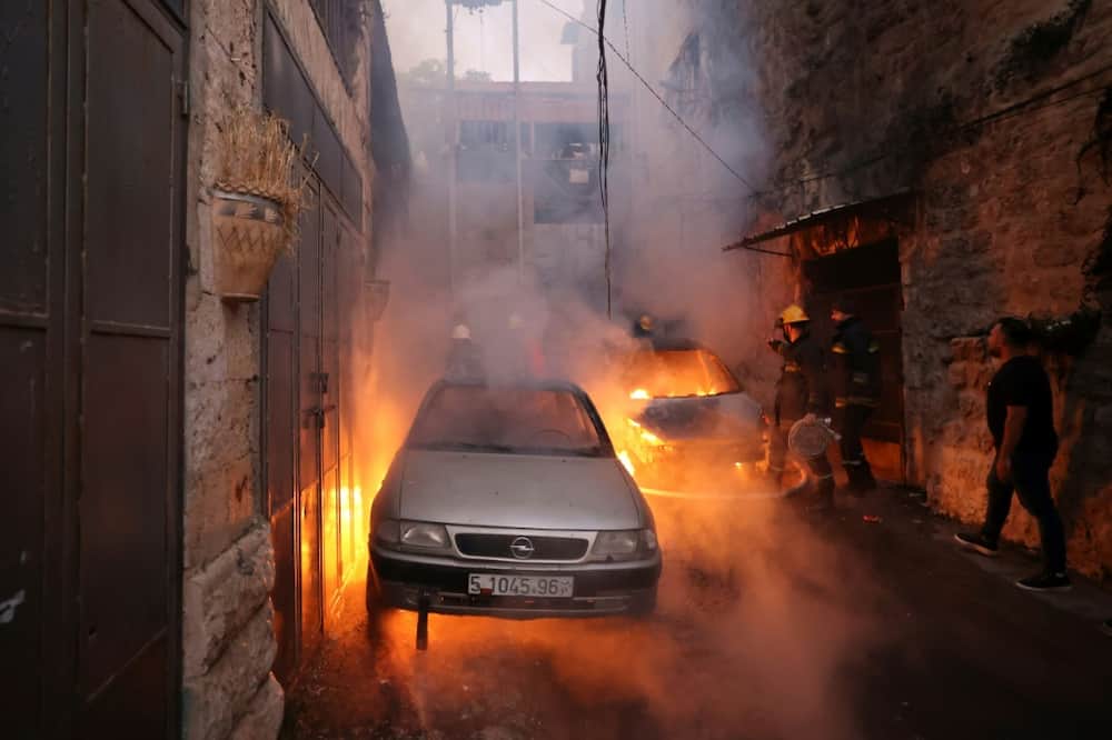 Palestinian rescue teams rush to the scene of clashes between Israeli troops and Palestinian gunmen in the Old City of Nablus in the northern occupied West Bank early on July 24, 2022