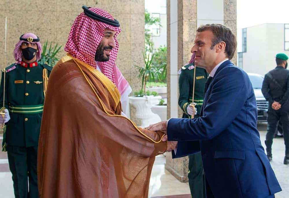 A handout picture provided by the Saudi Royal Palace shows Saudi Crown Prince Mohammed bin Salman receiving French President Emmanuel Macron in Saudi Arabia's Red Sea coastal city of Jeddah on December 4, 2021