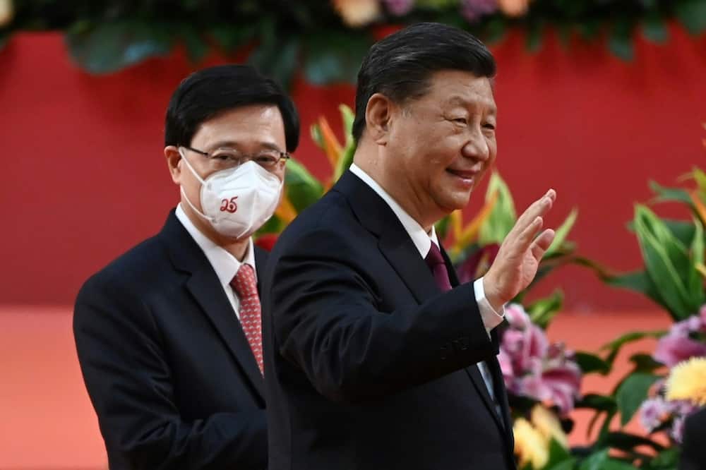 Hong Kong's new Chief Executive John Lee (L) said Chinese President Xi Jinping's (R) visit had been 'inspiring'