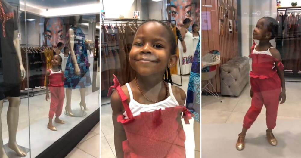 A little girl pretending to be a mannequin
