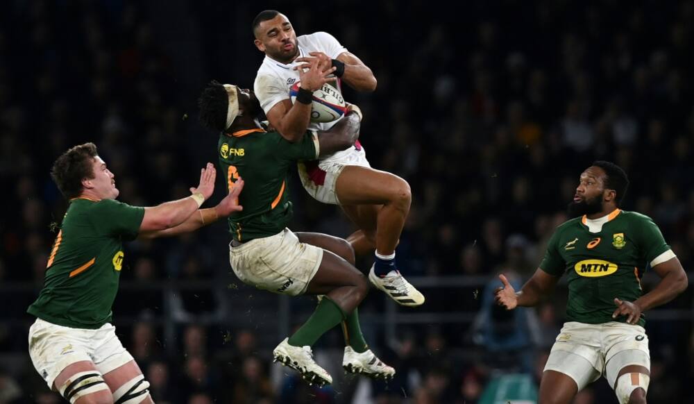 South Africa captain Siya Kolisi (2L) contests possession with England wing Joe Marchant (2R) in a November 2021 Test which England won 27-26 in London