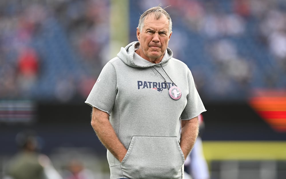 Bill Belichick of the New England Patriots stands on the field prior to the game