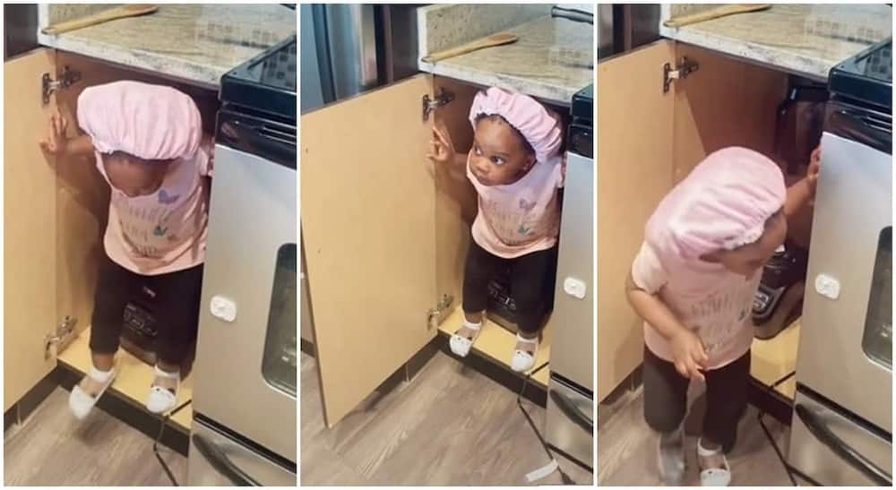 Baby sneaks into mum's kitchen and cupboard in viral video.