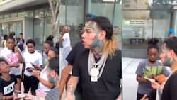 Tekashi 6ix9ine hands out $100 bills to young fans in the streets