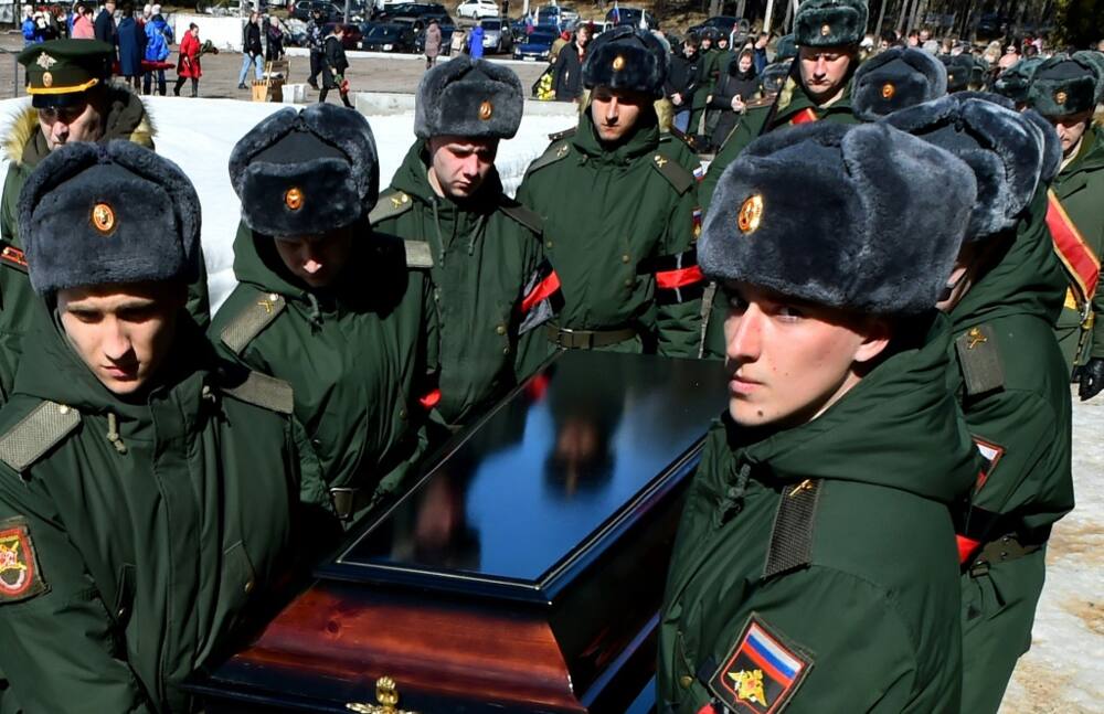 Soldiers carry the coffin of 20-year-old Russian serviceman Nikita Avrov, during his funeral at a church in Luga, some 150 kilometers south of Saint Petersburg, on April 11, 2022