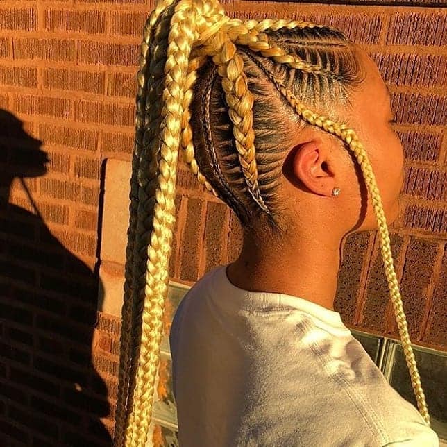 Stitched blonde cornrows with in-front-of-the-ear flowing braid