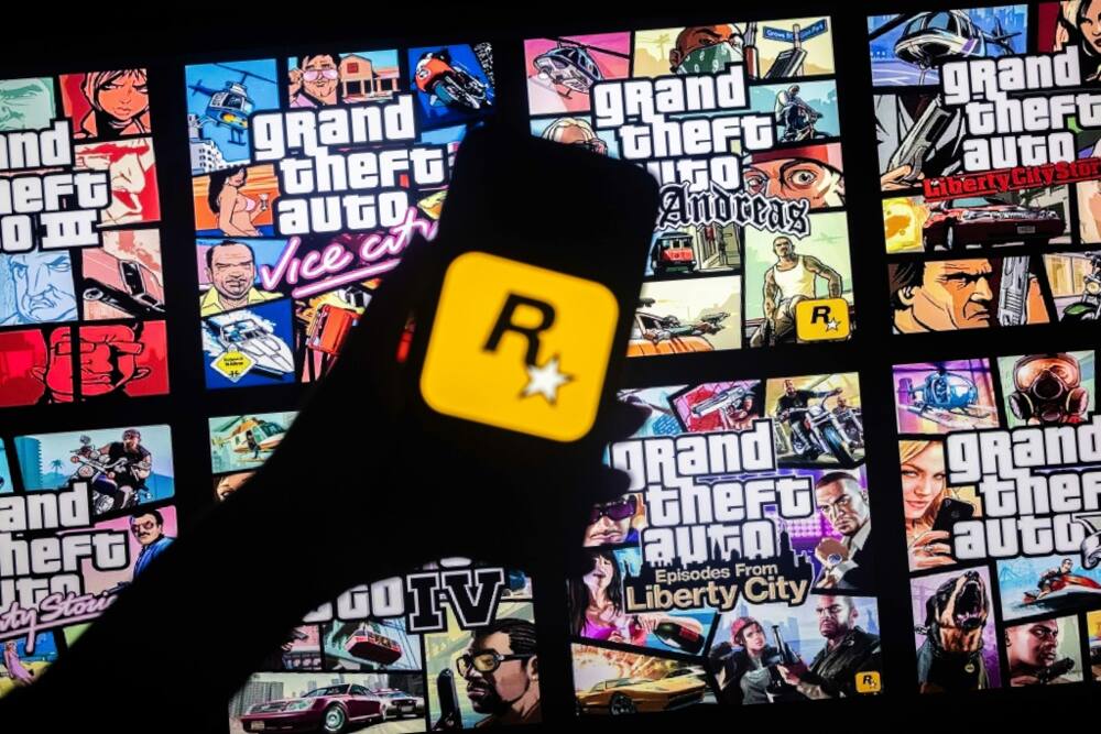 This illusttation shows a logo of Rockstar Games on a smartphone screen and covers of video game series Grand Theft Auto (GTA) on a TV screen in New York, November 27, 2023