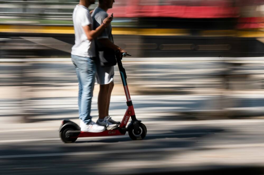 Riding an e-scooter with another person is illegal but commonplace on Paris's streets