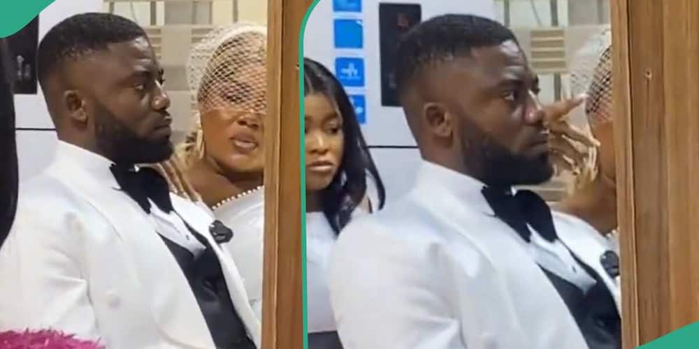 A Groom maintains a strong face during his wedding while his wife gossiped with him