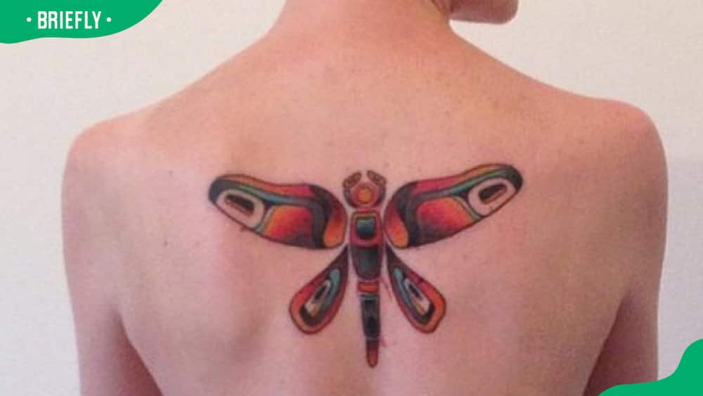 Bright red dragonfly tattoo