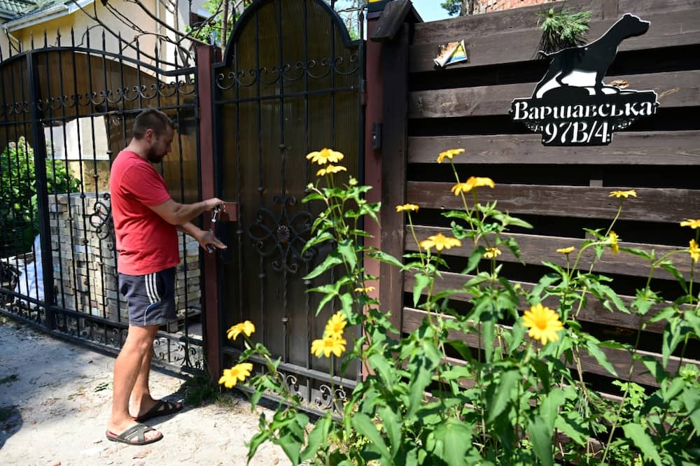 Yevgen opens the door to a home in Irpin which he has been looking after