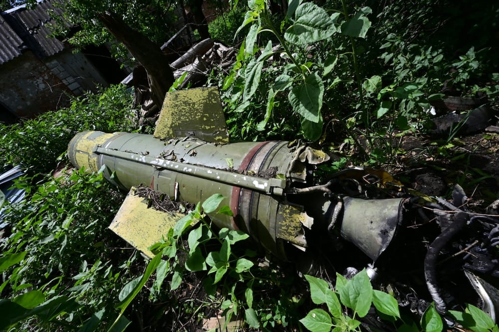 A Tochka-U missile lies in the courtyard of a nearby house