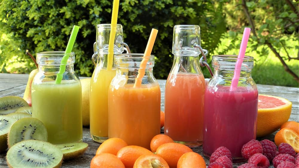 Assorted fruit smoothies in glass bottles